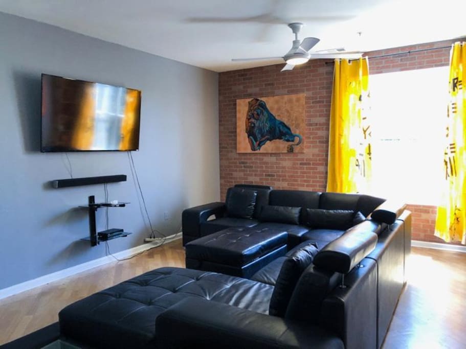 55" Smart TV with soundbar and surround sound system.