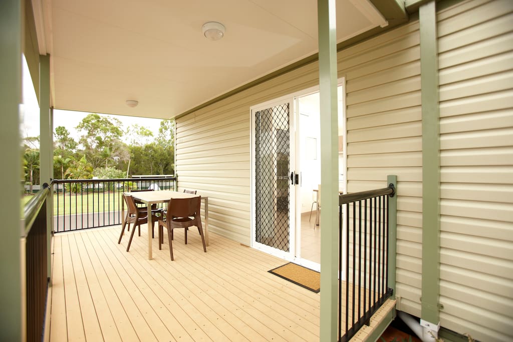Large undercover patio area with table and chairs.