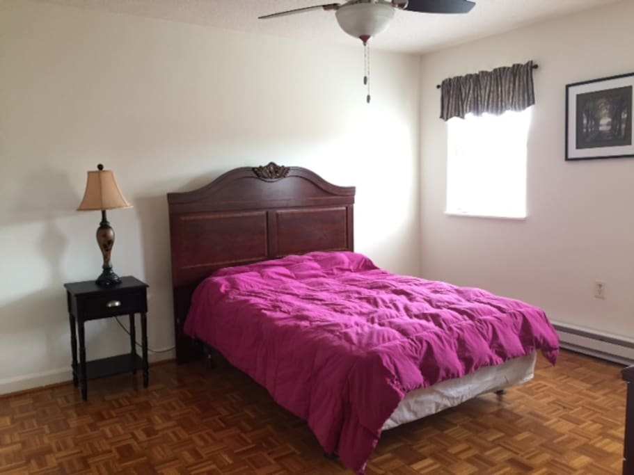 Full size, comfy bed with dresser and side table.