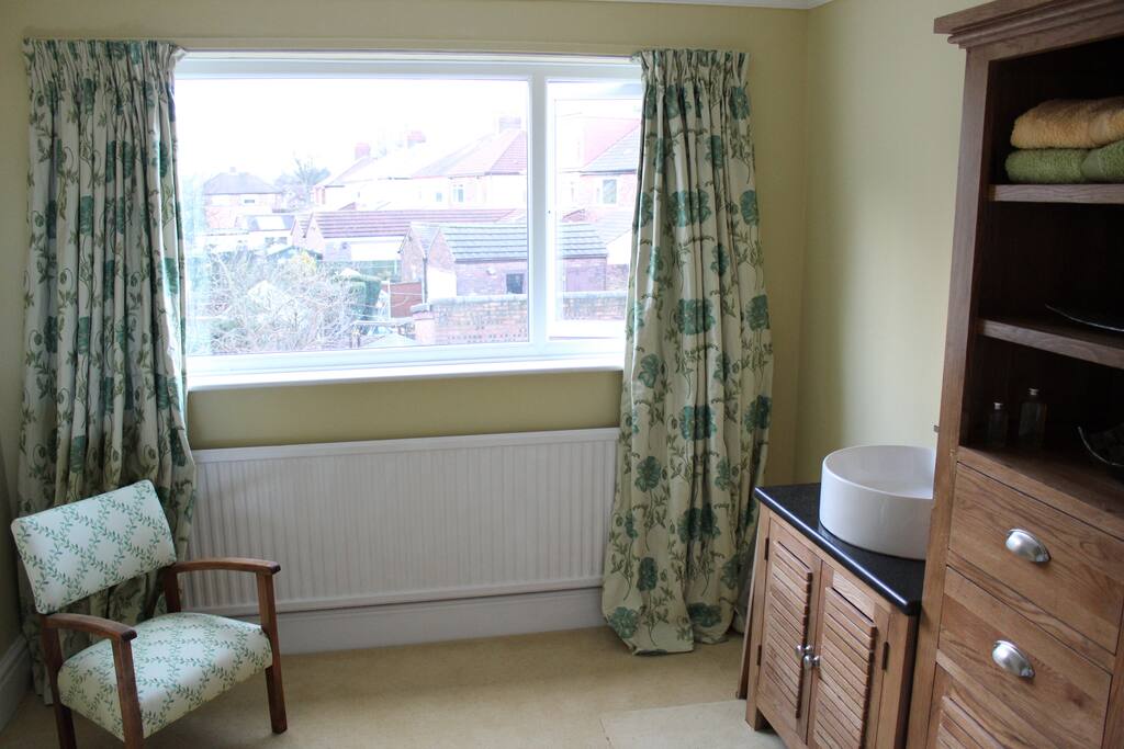 Yellow room with sink and vanity unit.
