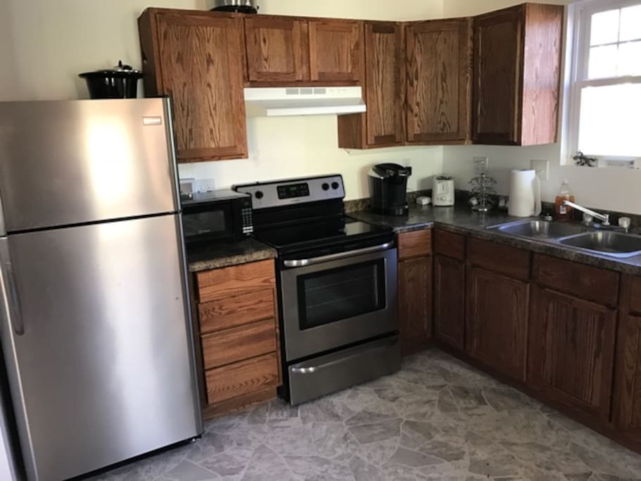 Full kitchen complete with kitchen table. Brand new appliances. Help yourself to the coffee, bottled water and snacks.