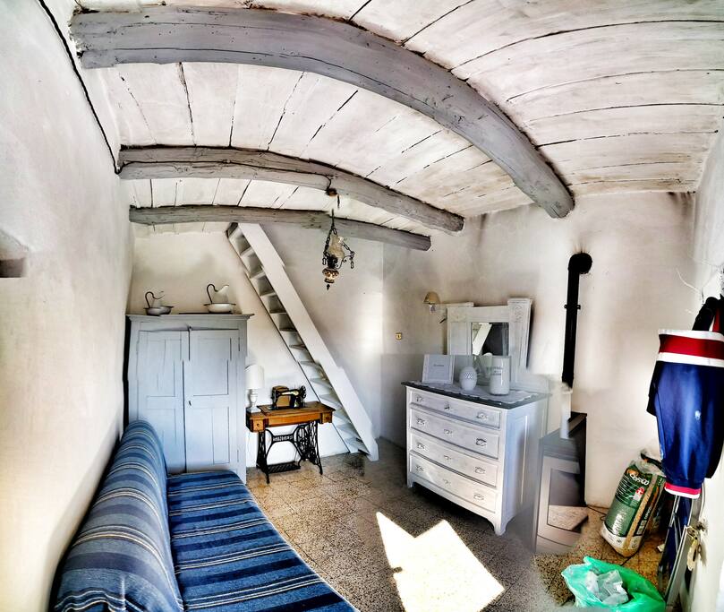 The living room, and the stairs to the bedroom