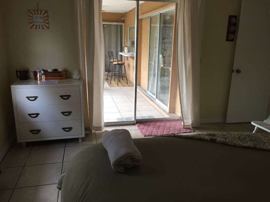Main Guest Bedroom with slider access to lanai and backyard. Chest of drawers, and closet for your convenience.