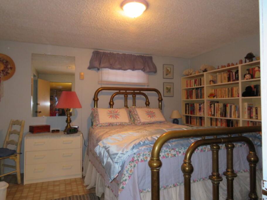 Queen bedroom with closet & drawers for your things also a desk.