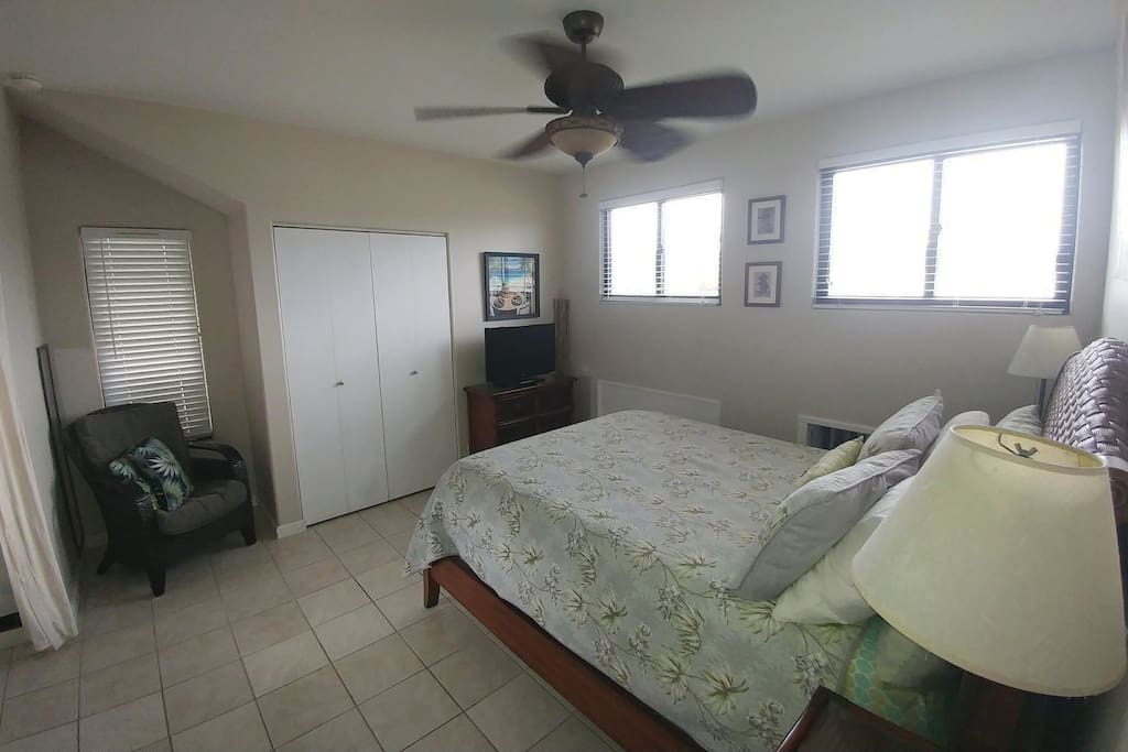 Large bedroom with queen sized bed and plenty of natural light