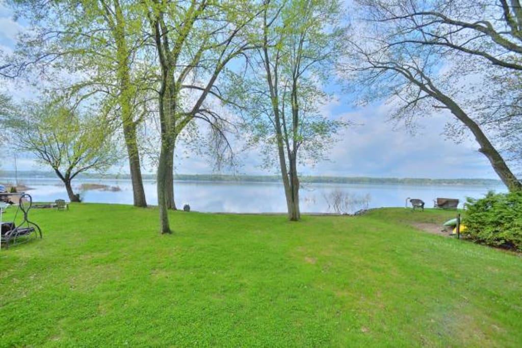 The view from the living room, the backyard going right to the water