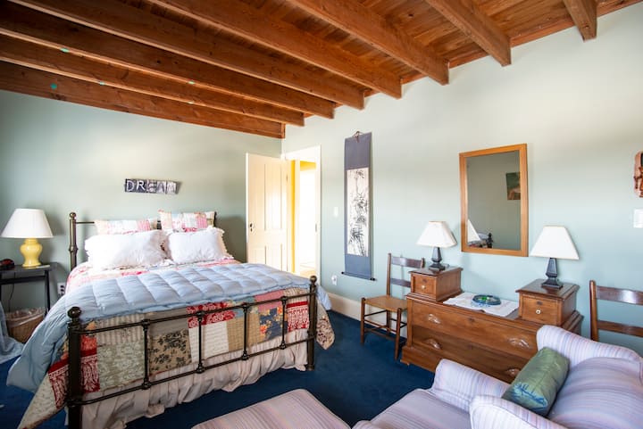 The Garden room has an inviting queen bed and a small sitting area. 