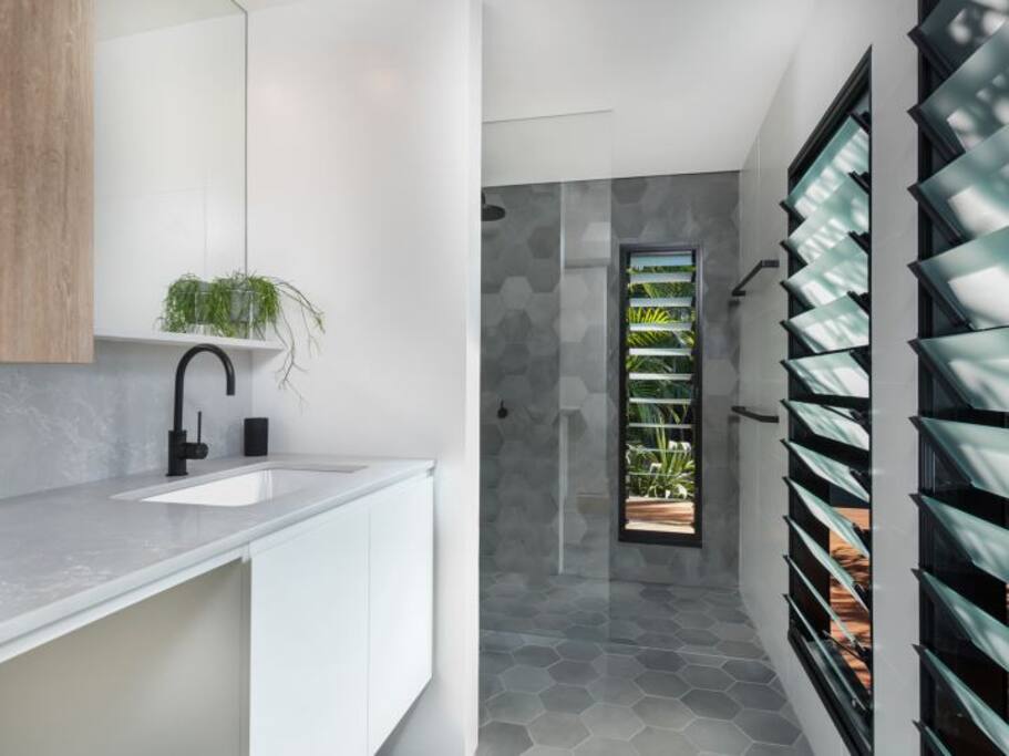Beautiful walk in shower. Washing machine is also located in the bathroom for guest use.