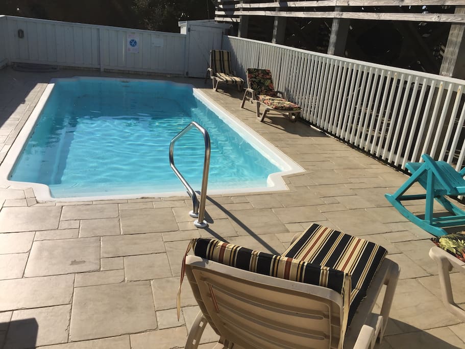 Large outdoor pool facing south, perfect for swimming and sunbathing.
