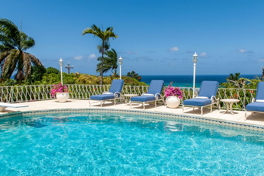 The terrace encircling the heated pool offers guests a stunning blue view over the Caribbean Sea.