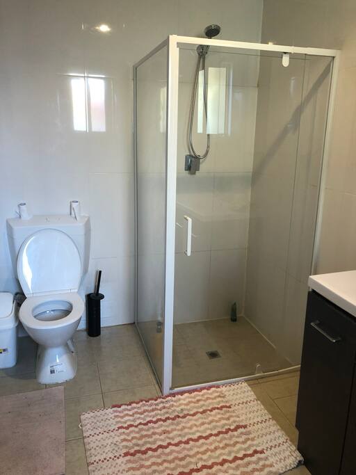 bathroom with washing machine and dryer as well.