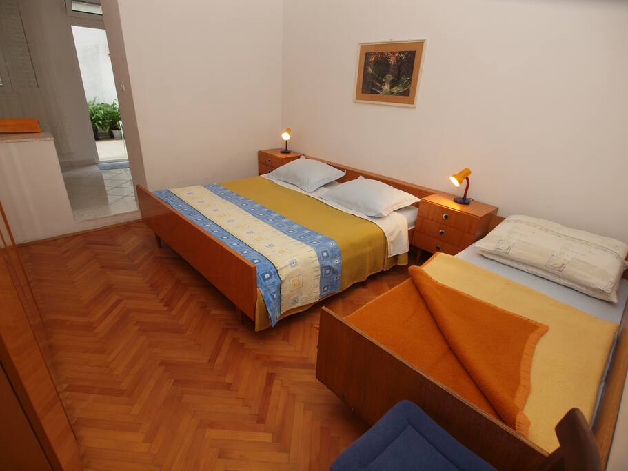 bedroom with double bed and one additional bed