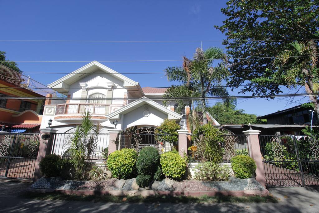 Front of house with guest parking left and right