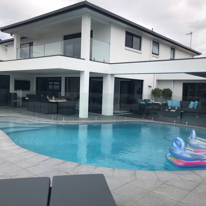 Generous size pool with floating loungers and poolside loungers