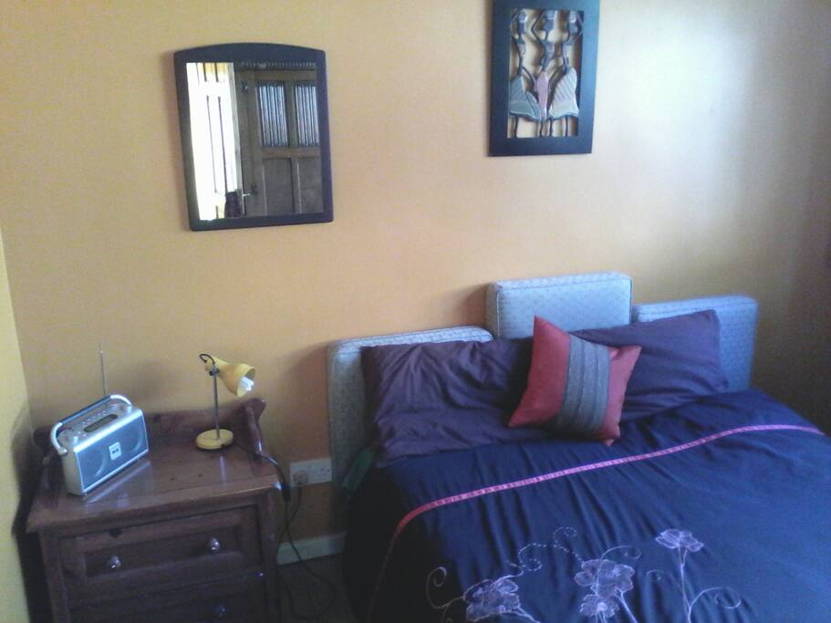 Your room, with double bed, wardrobe, digital radio and TV set.