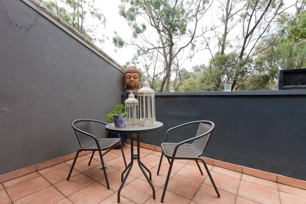Downstairs creek-side balcony with large 6 seater extendable table and awesome BBQ!