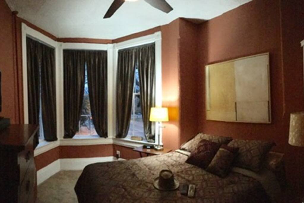 Master Bedroom with bay window overlooking prestigious East Capitol and Lincoln Park with views of ornate gazebo and fountain that adorn the flagstone patio at the entrance to the home.