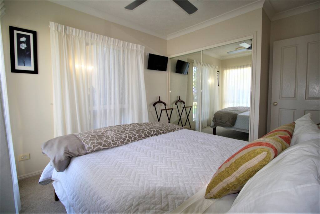 A comfortable private room with TV and storage.