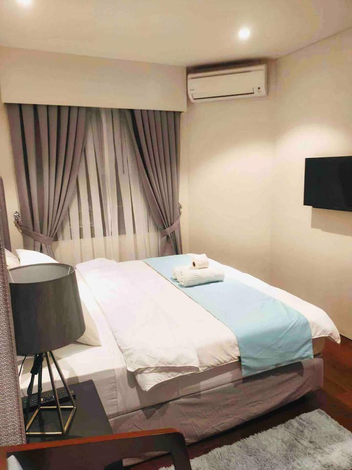 Ლუქს-კლასის და კომფორტული საწოლი დიდი ზომის თქვენი კომფორტისთვის, კედელზე მიმაგრებული სმარტ-ტელევიზორით.