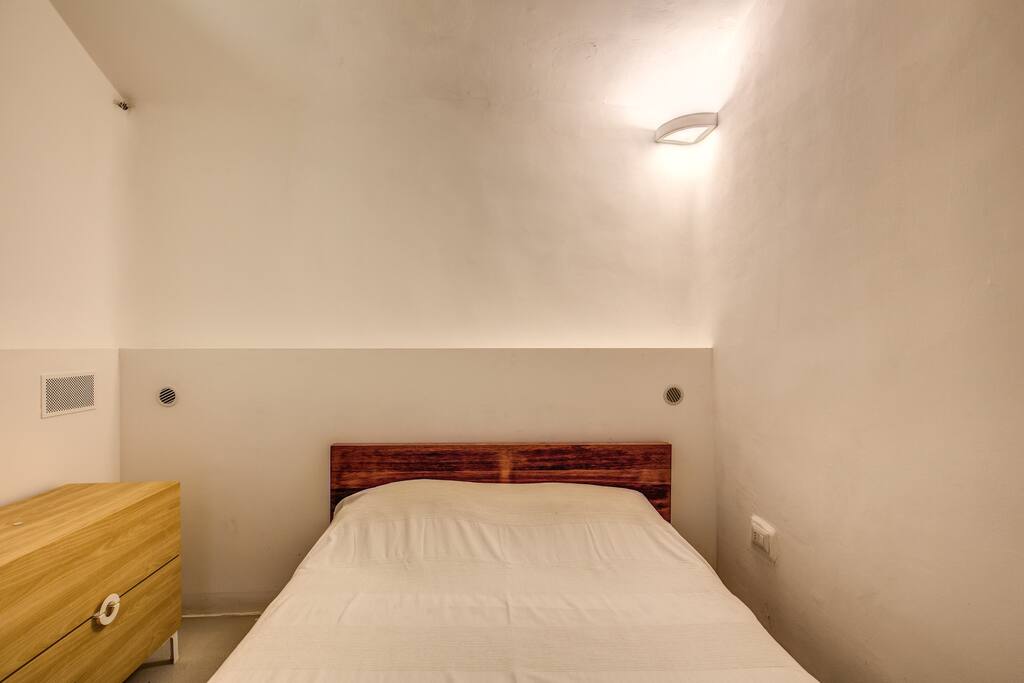 Bedroom with a double bed, dresser, heater and dehumidifier