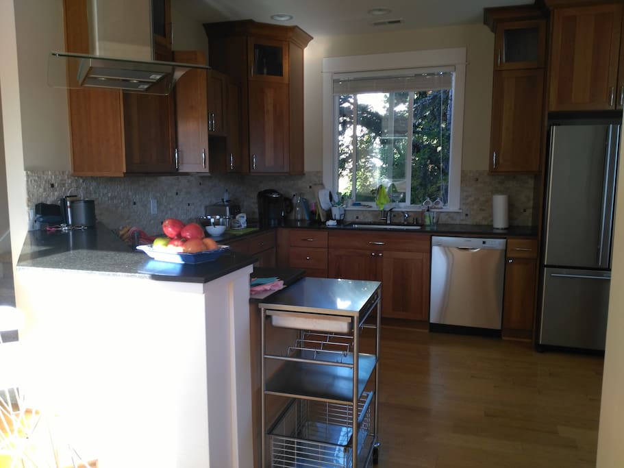 Spacy kitchen and a bar table with three seats