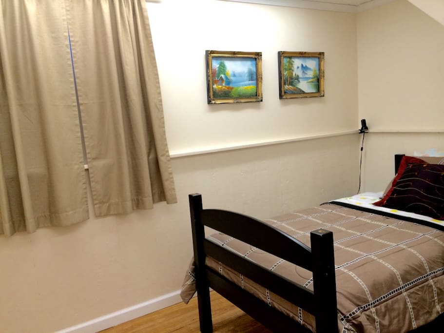 The room, located under the stairs, with tiny non-standard windows, walk-in closet and tables.