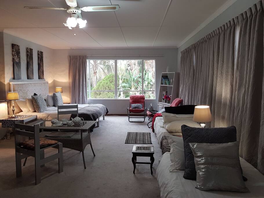 a Spacious family suite with garden views through large windows on three sides