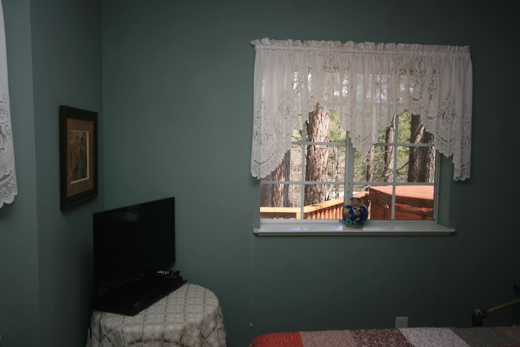 Your quiet room is at the far end of the home, overlooking the deck, hot tub, and a wooded lot.