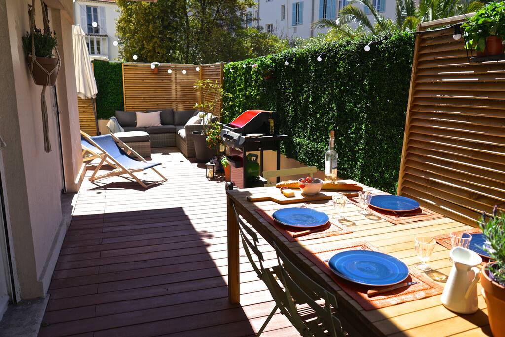 Terrace with large dinner table, bbq, lounge group and sun-chairs