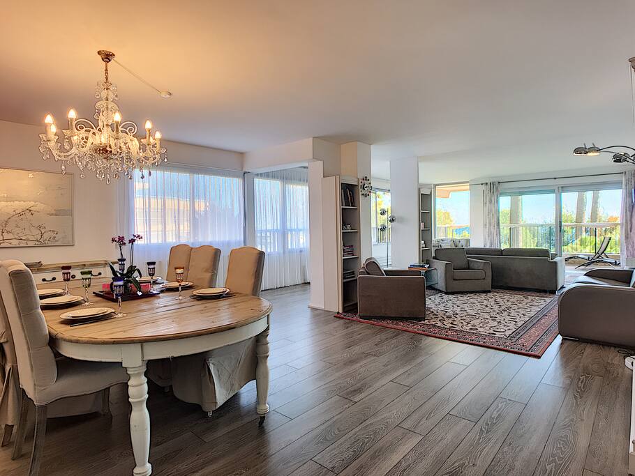 Our spacious and cozy living room with several rest areas, dining area and big terrace and beautiful sea view