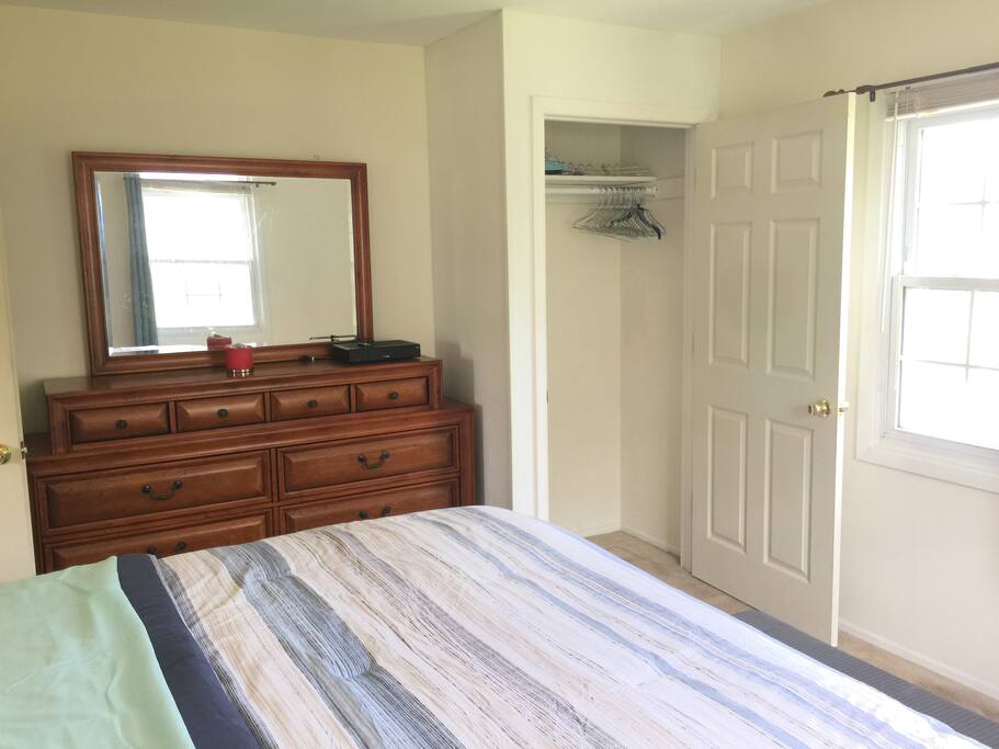 Long, Full Length Dresser with Mirror, as well as closet with hangers.