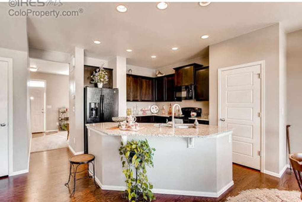 Open kitchen with granite tops and new appliances