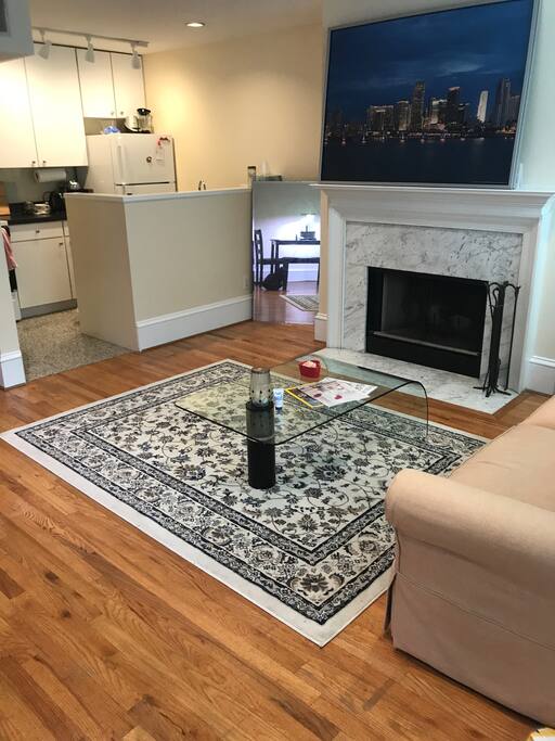 Living/Kitchen Area couch has been moved and a large HD tv with Apple TV has been added
