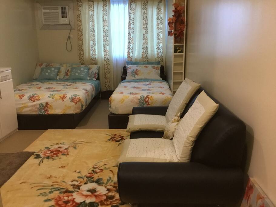 Comfortable two beds, with soft sheets, comforter, fluffy pillows, and a relaxing sofa make you feel at home