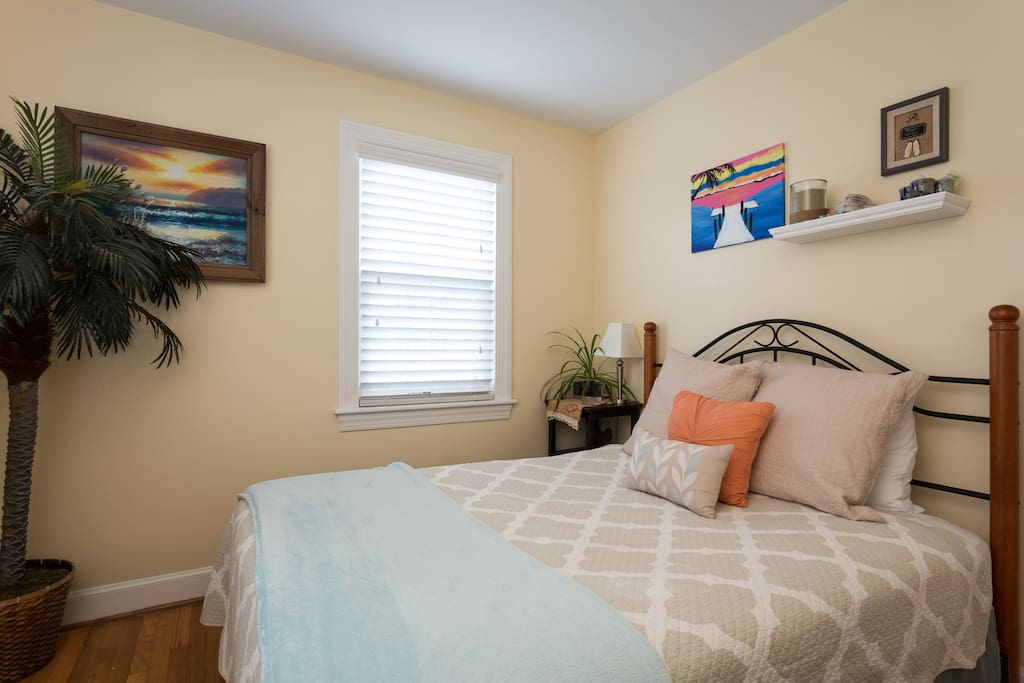 Your cozy bedroom full of local artwork.