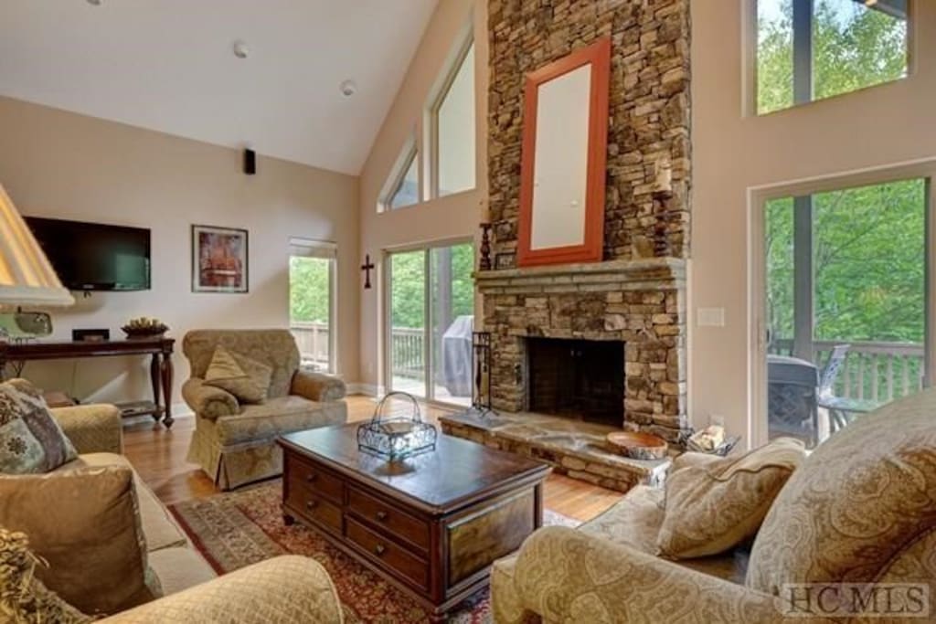 Huge great room with stone Fireplace and 25ft ceiling