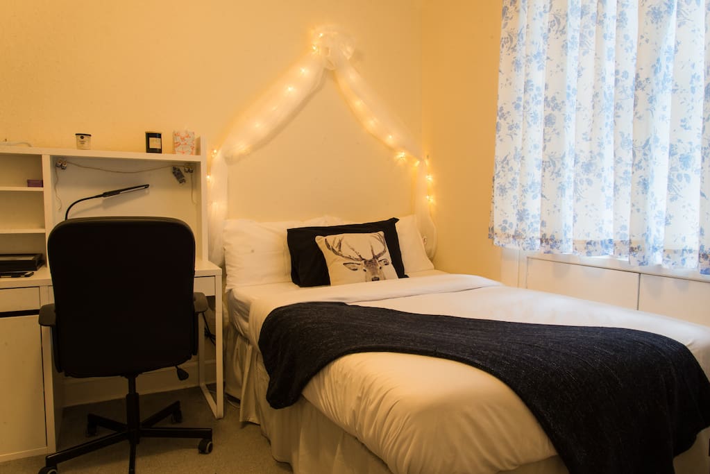 Bed with working desk in the bedroom