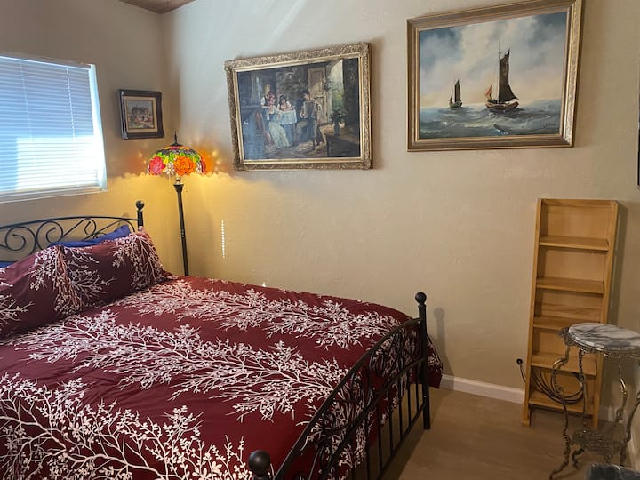 Smaller bedroom, Queen Size Bed, Pillow top Mattress Many people have commented how comfortable this bed is! Tall Tiffany Lamp, Great artwork.