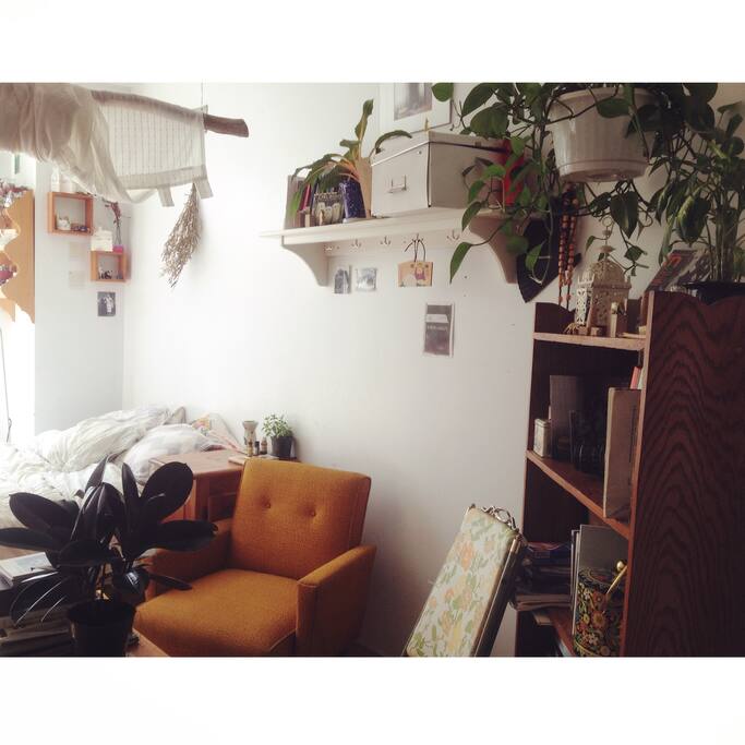 Little "living room" area next to the bed with a library and a small table to read a book or have a cup of tea.