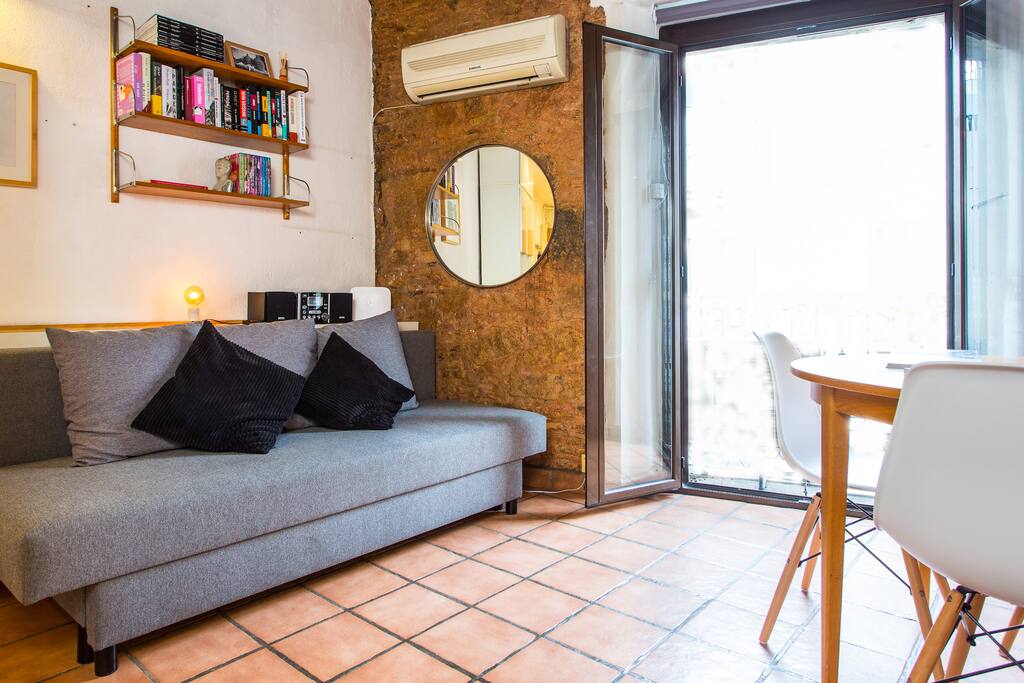 Living + dining area with comfortable sofa bed