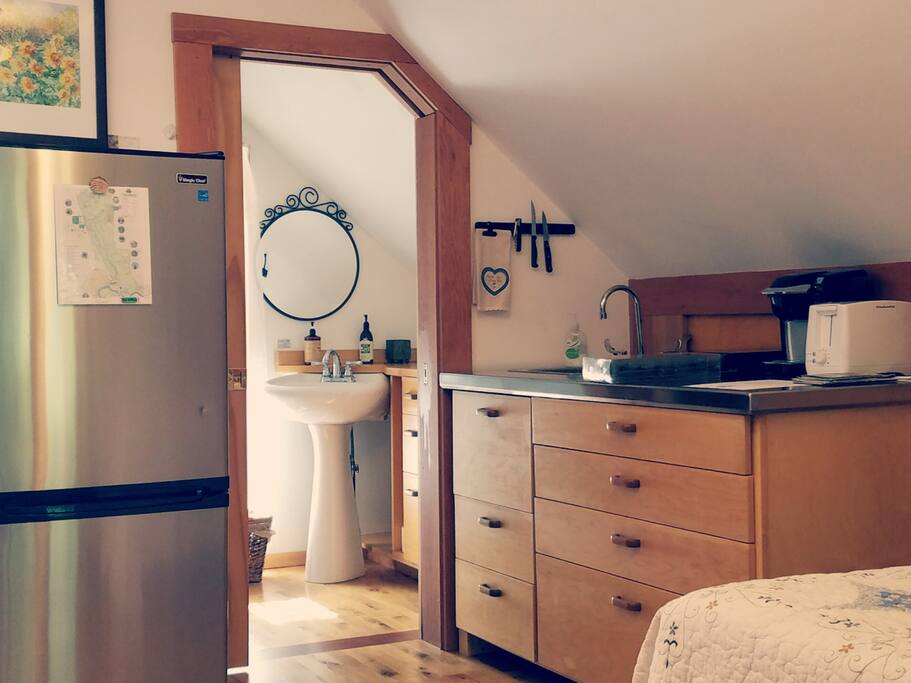 Kitchenette with fridge/freezer, hot plate, kuerig, toaster, sink, dishes and pots/pans