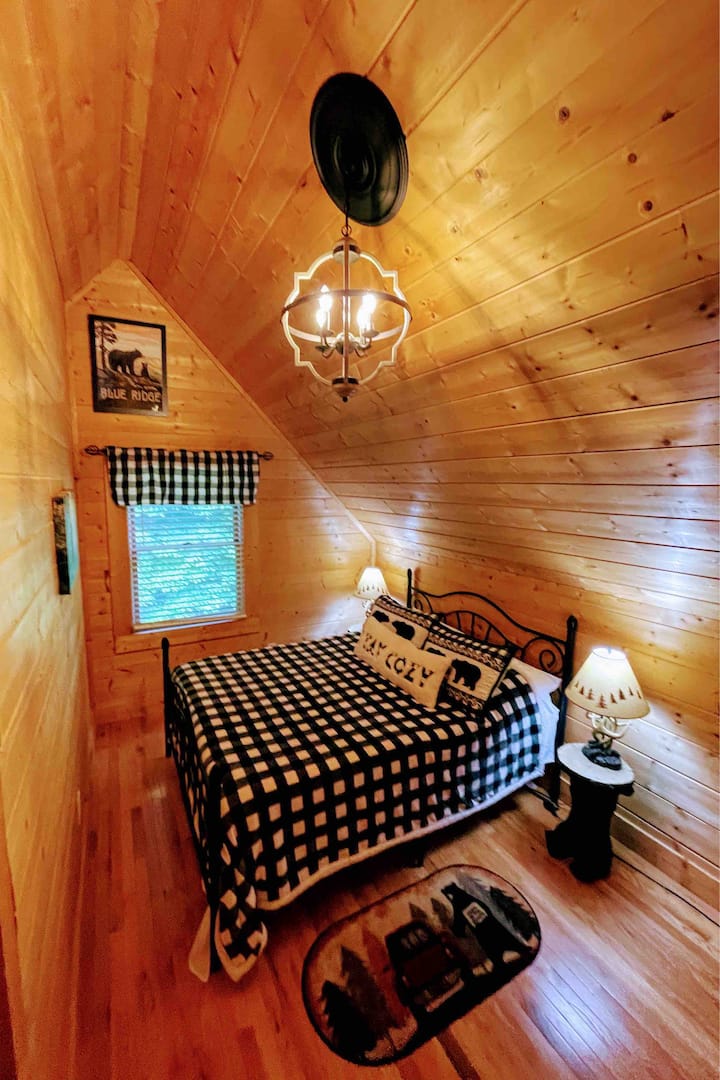 Loft bedroom with queen bed, attached bathroom & a TV with DVD player. We provide DVD’s with great movies for all ages.