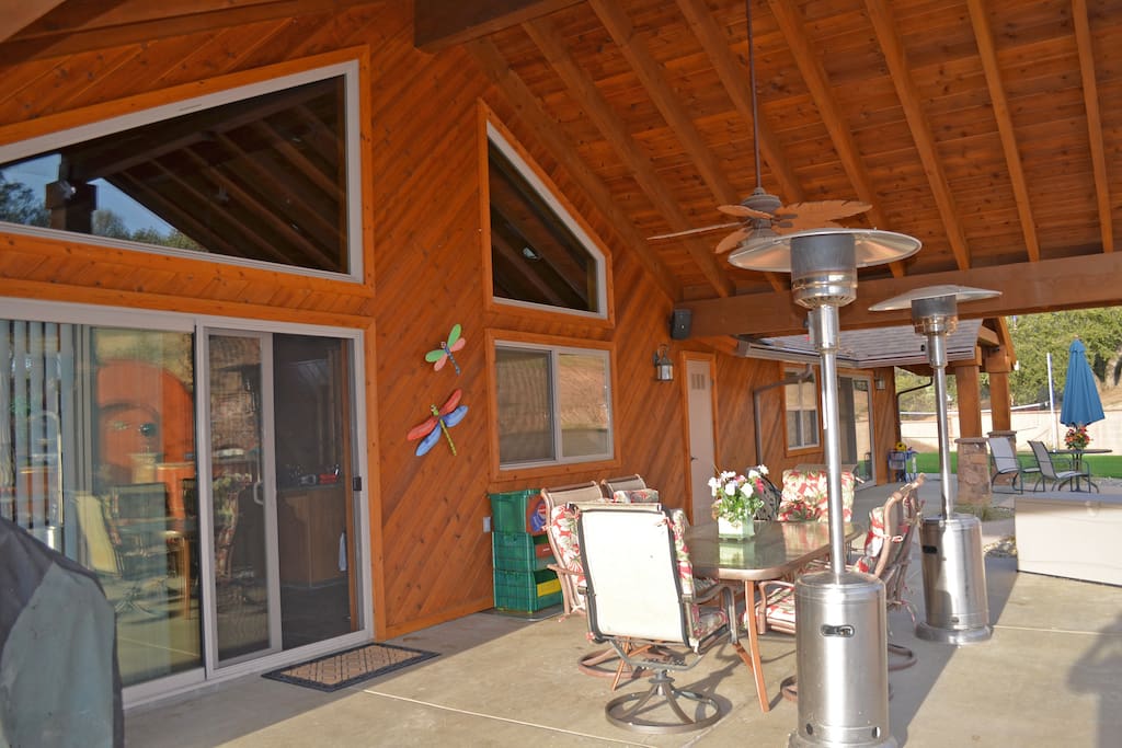 Covered patio with swivel chairs and nice cushions.