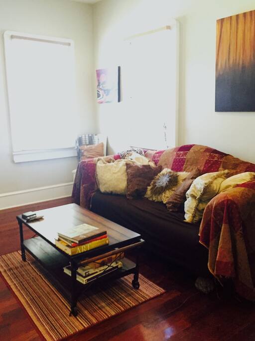 Living room with table on wheels to rearrange furniture as needed for extra people. The bedroom door separates the two spaces for privacy....