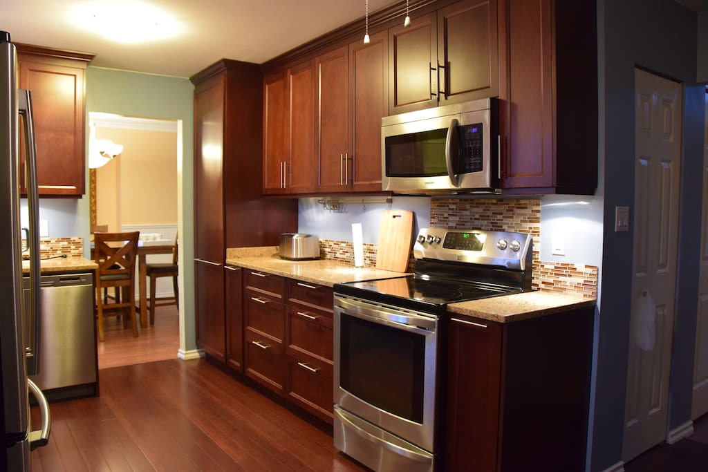 Kitchen, includes stove, dishwasher, microwave, toaster, coffee machine, oven, and necessary tools for cooking
