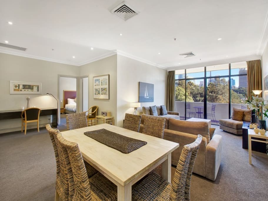 Spacious dining/living area with flat screen, plasma TV, cable TV, sound system and workstation desk
