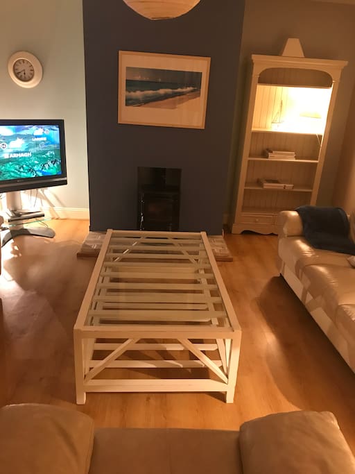 Living room with wood burner and 42” tv with saorview