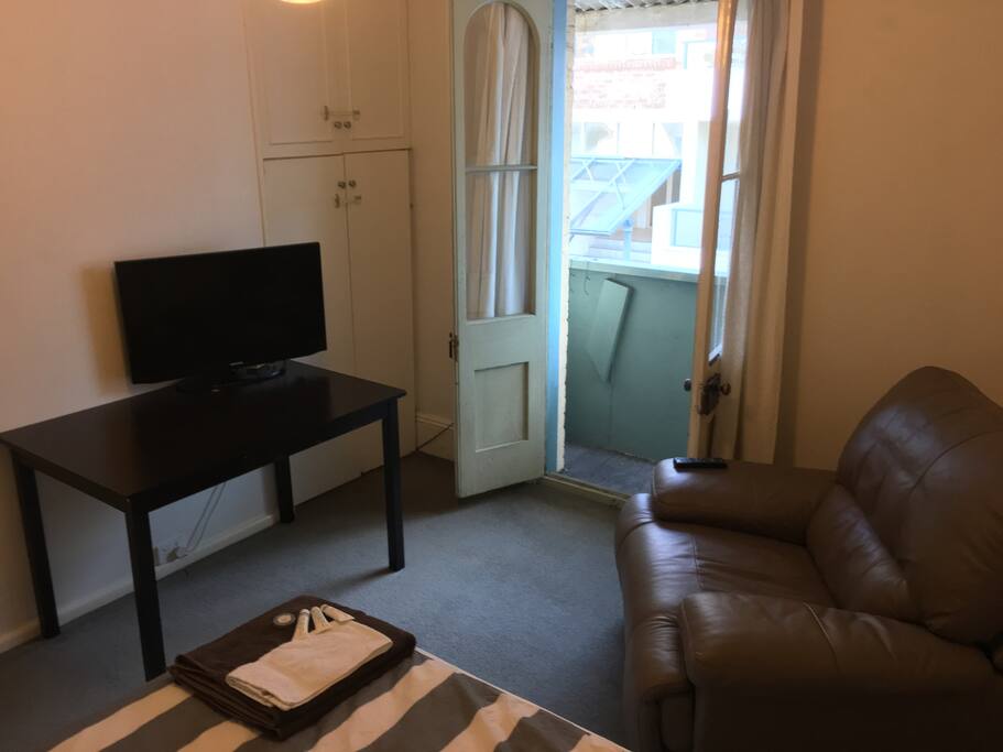 Your bedroom with balcony, tv and reclining lounge chair