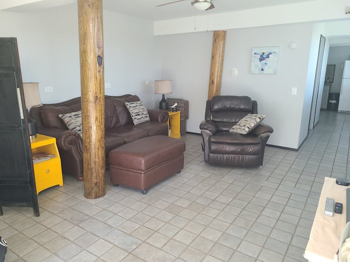 Living room: leather couch, recliner, ottoman, side tables and USB lamps