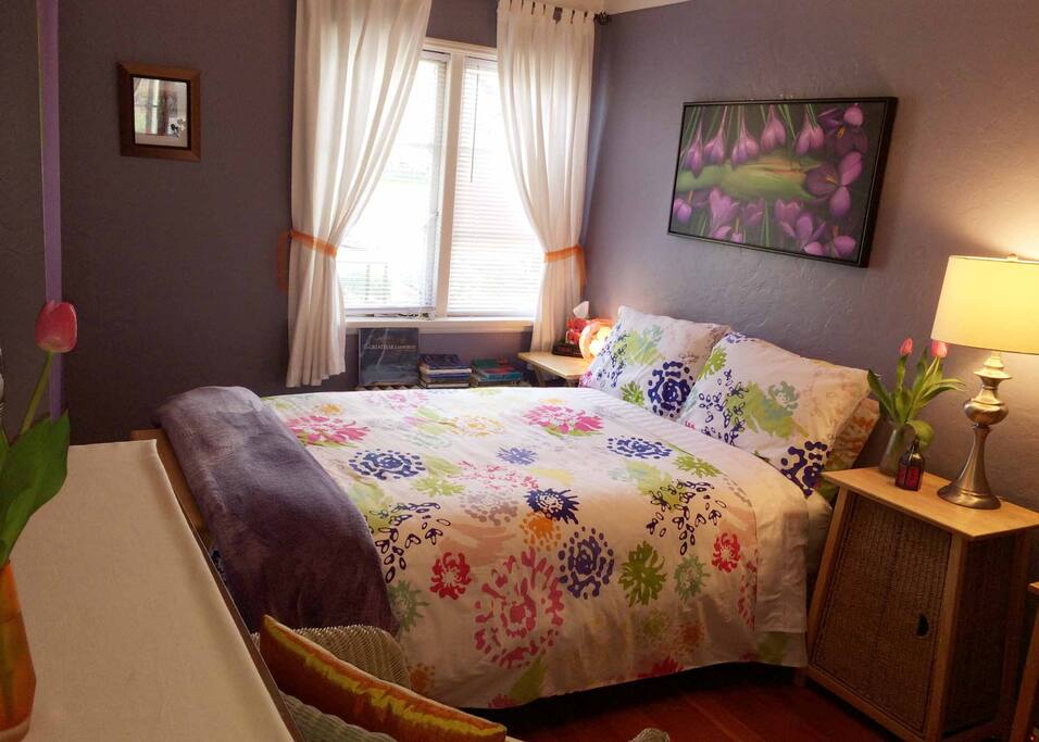 Your beautiful and tranquil guest room awaits! Beside the bed there's a curated selection of bedtime reading materials , lamps, and a clock in case you need it.